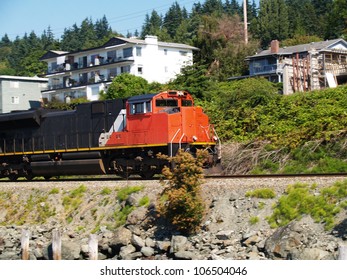 Orange Black Train Engine Going Down Tracks