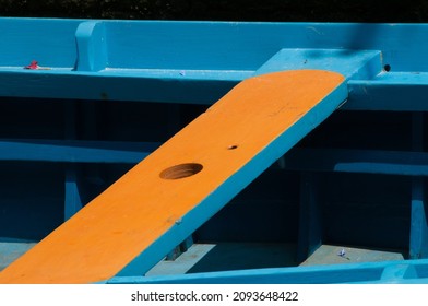 orange and blue rowboat bench, wood

