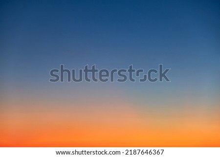 Orange and blue sunset sky gradient, copy space background. Red evening sky without clouds