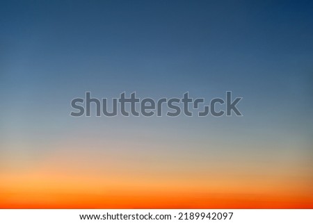Orange and blue sunset sky gradient, copy space background. Red evening sky without clouds