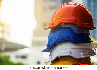 Orange, blue,  white and yellow hard safety helmet hat. Engineer, Construction and Safety Concept.
Copy Space.