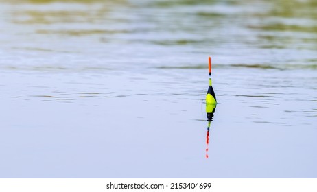 Orange Bobber On The Water Surface