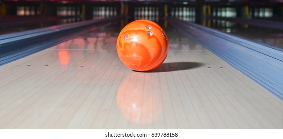 Orange Bowling Ball On The Track. Active Leisure. Sport Game.