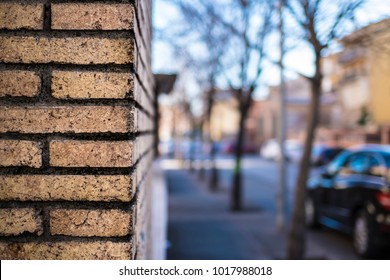 Orange Brick Wall Close Up Textured On A Corner Street With Blurred Outdoor Cityscape