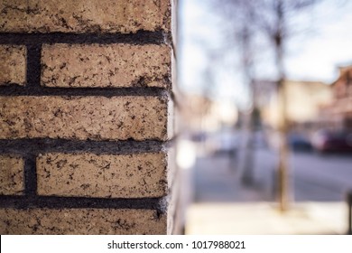 Orange Brick Wall Close Up Textured On A Corner Street With Blurred Outdoor Cityscape