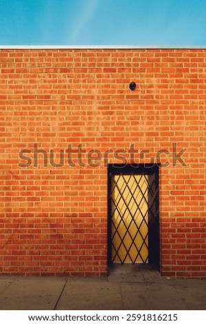 Orange brick wall with yellow pattern door