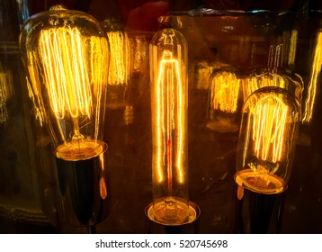 Orange Bright Glowing Light Bulbs Illuminate The Night With Electricity Ideas And Concepts From A Historic Idea Powering The Future Of Evolution And Change For Man Kind