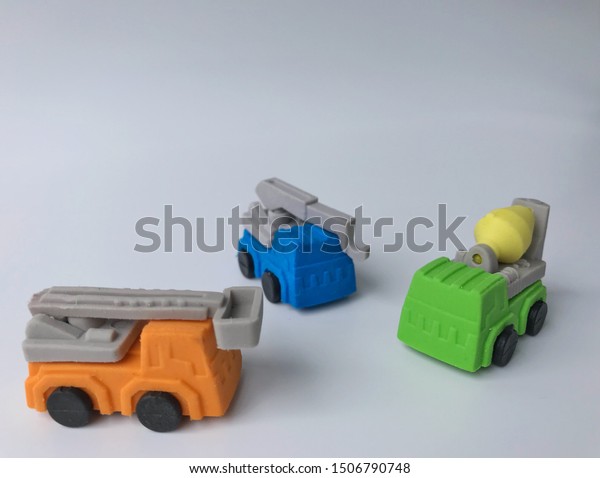 The orange bucket\
truck, blue crane truck and green concrete mixer truck are isolated\
on white background.
