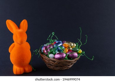 Orange Bunny With A Filled Easter Basket And Sweet Eggs