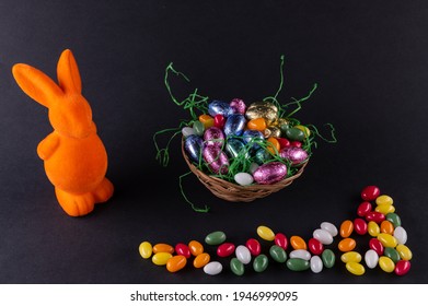 Orange Bunny With A Filled Easter Basket And Sweet Eggs