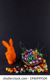 Orange Bunny With A Filled Easter Basket And Sweet Eggs