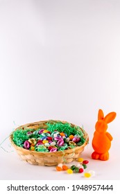 Orange Bunny With A Filled Easter Basket And Sweet Eggs