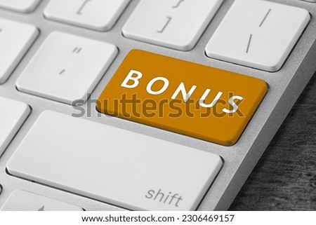 Orange button with word Bonus on computer keyboard, closeup