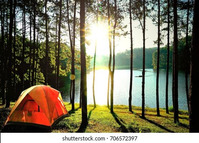 Orange camping tents in pine tree forest by the lake at Pang Oung Lake (Pang Tong reservoir), Mae hong son, Thailand. - Powered by Shutterstock