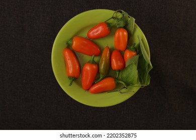 Orange Capsicum On A Green Plate