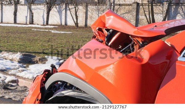 Orange car crash background. Close-up detail of\
auto wreck. Front side of crashed car from accident. Car accident.\
Generic cars crashed.