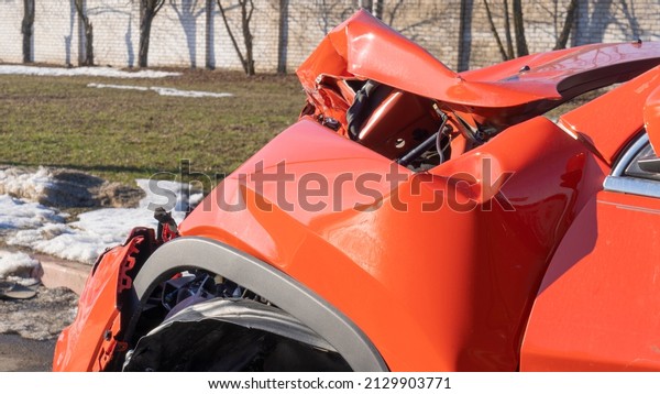 Orange car crash background. Close-up detail of\
auto wreck. Front side of crashed car from accident. Car accident.\
Generic cars crashed.