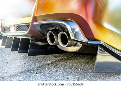 Orange car with dual exhaust pipes on concrete. Custom cars in Southern California summer 2017 - Powered by Shutterstock