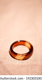 Orange carnelian stone ring and stripes  Vertical photo in macro style  There is space for text 