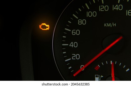 orange check engine light on the dashboard