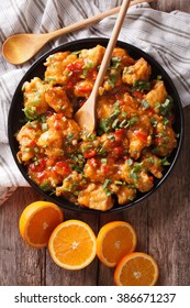 Orange Chicken In Sweet And Sour Sauce On A Plate Close-up On The Table. Vertical View From Above
