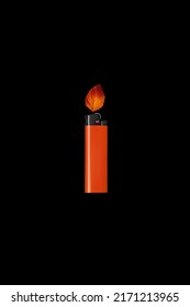 Orange Cigarette Lighter With Orange Autumn Leaf On Black Background. Fake Fire. Creative Art Concept. Minimal Nature Concept. Banner With Copy Space Ready For A Text.