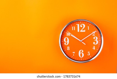 Orange Clock On Orange Background