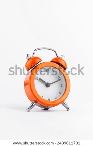 Orange The clock sets the time to 10.00. on white background isolate
