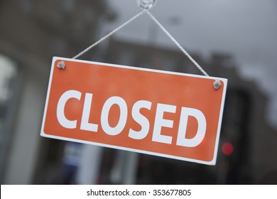 Orange Closed Sign On Shop Door