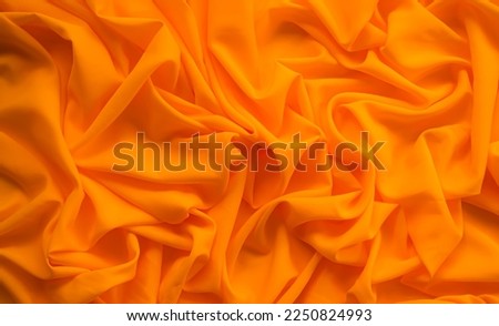 Orange cloth Background,Texture Pattern Yellow Color Fabric,Light on Silk,Luxury Banner Abstract Summer Design Card or Poster,Soft Smooth Wallpaper Fasion colorful Gradient Shape Mouck Up,Blur Soft.