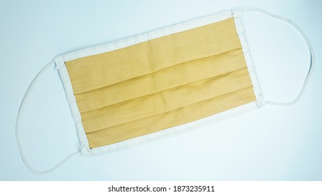 An Orange Cloth Facemask On A White Background