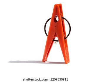 Orange Clothespin Close-up On A White Background. Plastic Old Clothespin Isolated On White