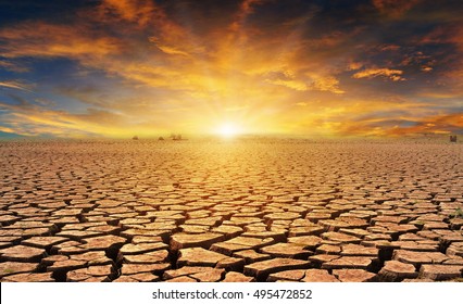 Orange Cloudy Sunset Over Cracked Desert