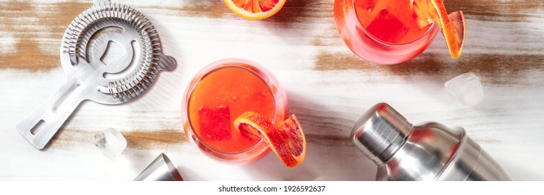 Orange Cocktail Panorama With A Shaker And A Jigger, Overhead Flat Lay Shot