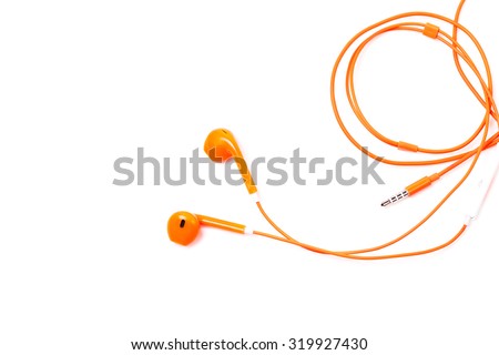 Orange color earphone on background.