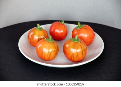 Orange Color Eggplants With Stripes On Gray Plate. Turkish Orange Heirloom Aubergine In A Circle.