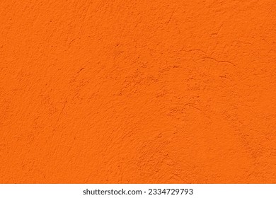 Orange color textured concrete wall with space for text