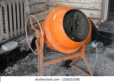 Orange Concrete Mixer Prepares Cement Mortar