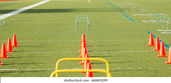 Orange Cones And Green Hurdles Are Set Up For Agility Training On A Turf Field