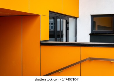 Orange contrasting elements in modern architecture. Bright accent. Architectural detail of a modern apartment building.