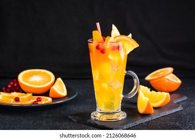 Orange Cranberry Fizzy Cocktail In A Glass And Fruits Next To It On A Dark Background. Homemade Mocktail