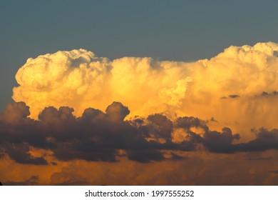 Orange cumulonimbus cloud at sunset 