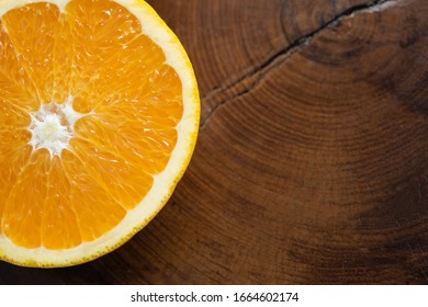 Orange cut in half on rustic wooden table