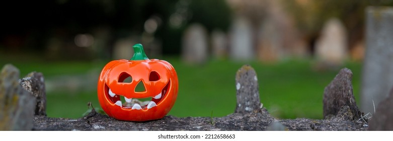 Orange decorative pumpkin for Halloween on a stone fence. Banner - Shutterstock ID 2212658663