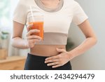 Orange detox juice, good digestive, young woman hand on stomach, belly with glass of vegetable juice, carrot smoothie for diet, girl drinking healthy meal food for weight loss isolated on background.