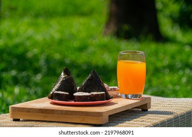 Orange Drink With Ice On Summer Sunny Garden Background. Fresh Cocktail Drinks With Ice Fruit And Herb Decoration