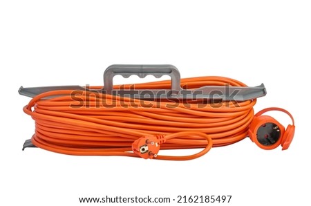 Orange electrical extension cord with plug and socket wrapped around plastic holder isolated on white background