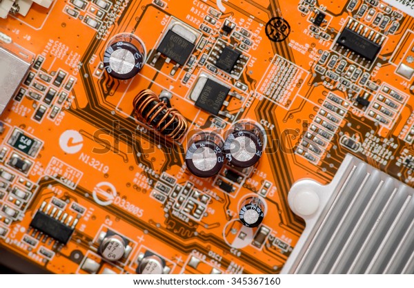 orange electronics computer part chip with\
many electrical\
components