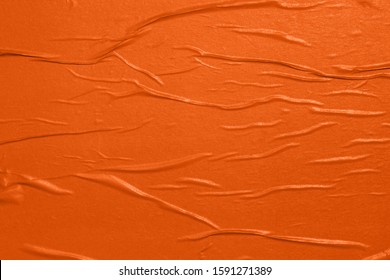 Orange empty crumpled and wet texture paper. Creased grunge paper background. Art rough stylized blank for a billboard, poster or banner with space for text. Copy space.