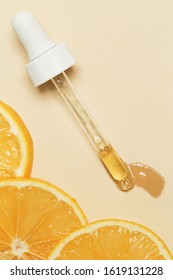 Orange Essential Oil, Eye Dropper Pipette And Orange Slices